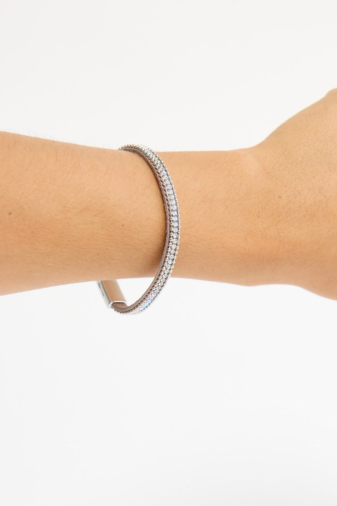 Harper Bracelet worn on the wrist against a plain background, highlighting the silver-tone clasp and crystal detail
