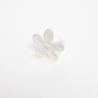 Silver-tone adjustable ring with a large daisy flower top featuring textured petals and a crystal centre, shown at an angle on a white background