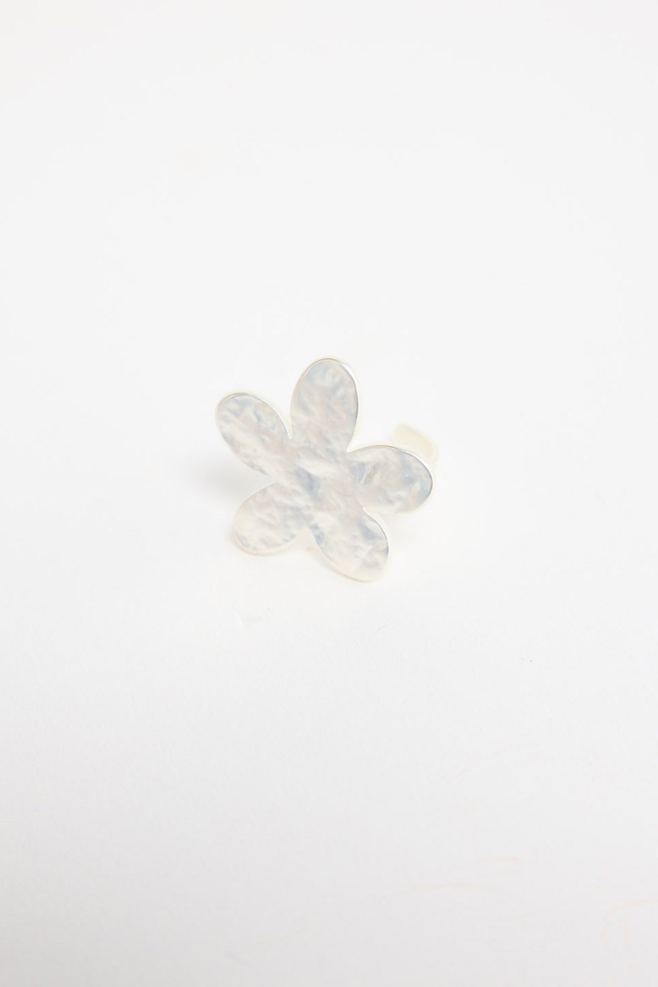 Silver-tone adjustable ring with a large daisy flower top featuring textured petals and a crystal centre, shown at an angle on a white background