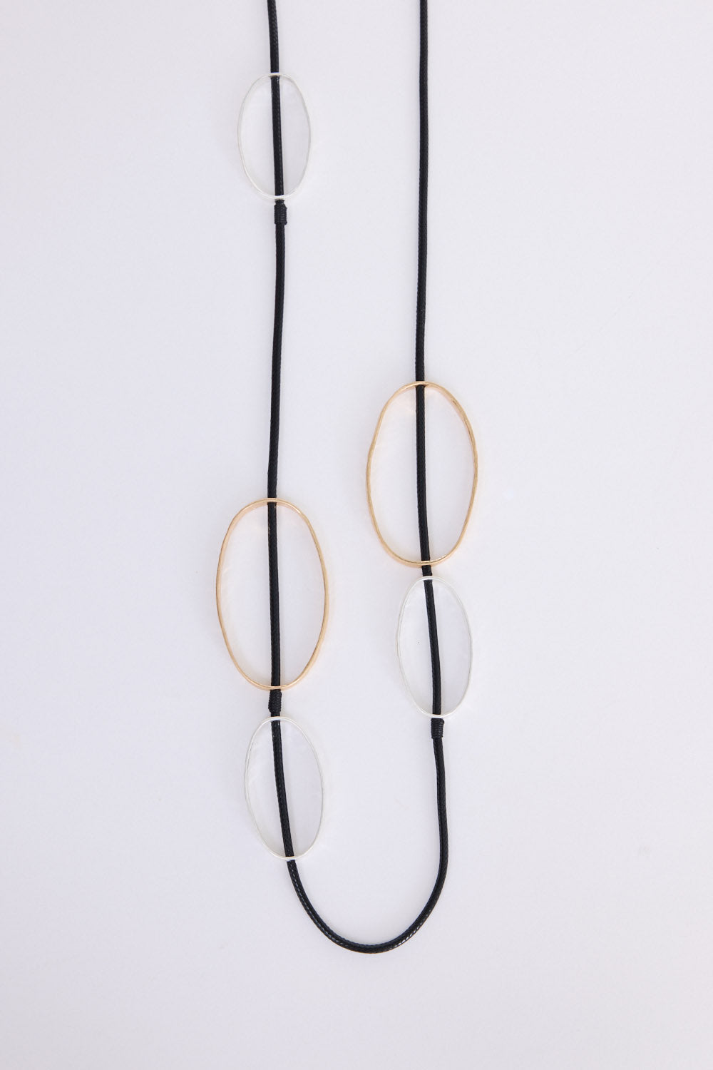 Rowling Necklace in gold and silver, with statement metal detailing, side view.