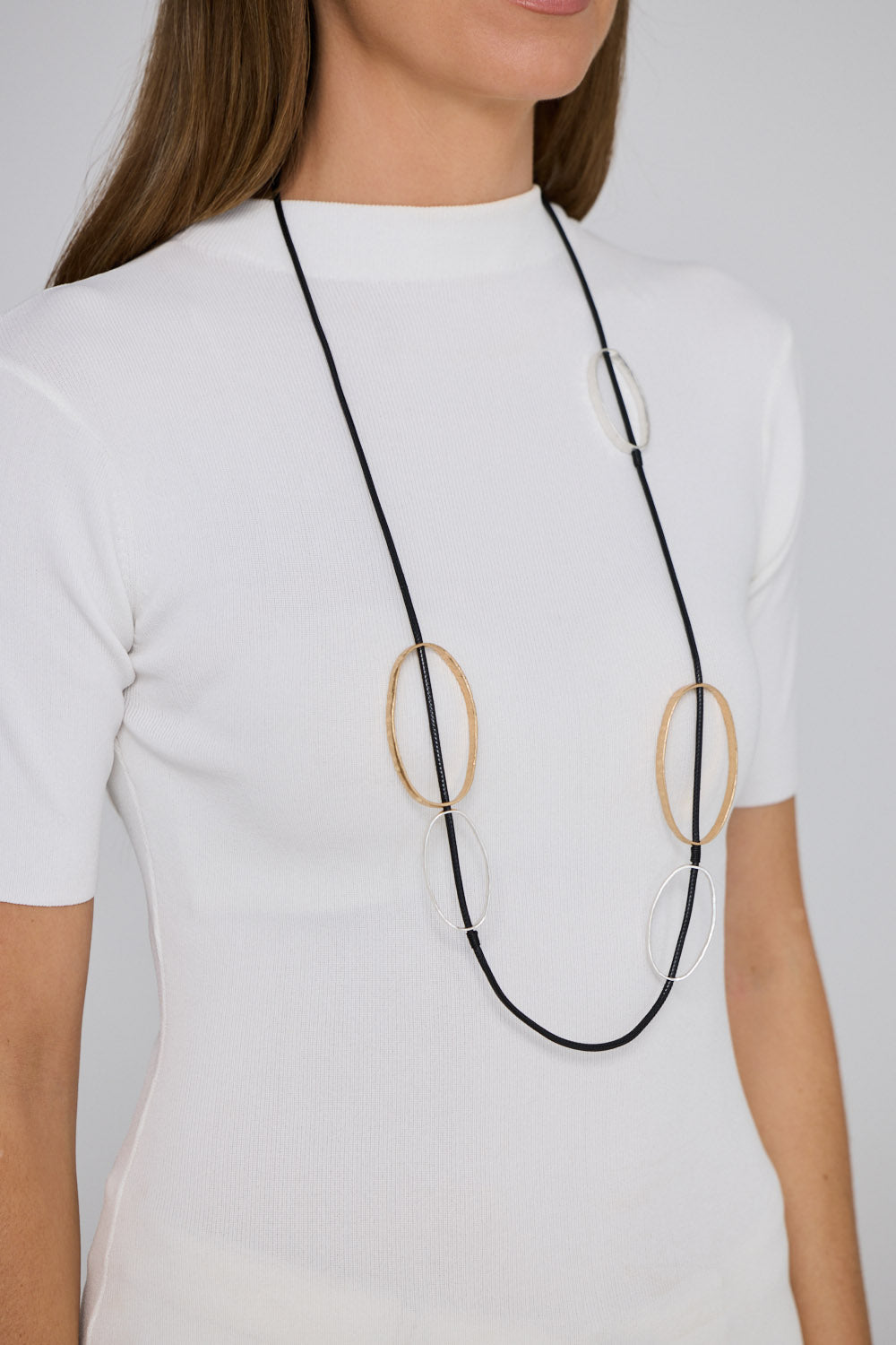 Rowling Necklace in gold and silver, with statement metal detailing, front view.