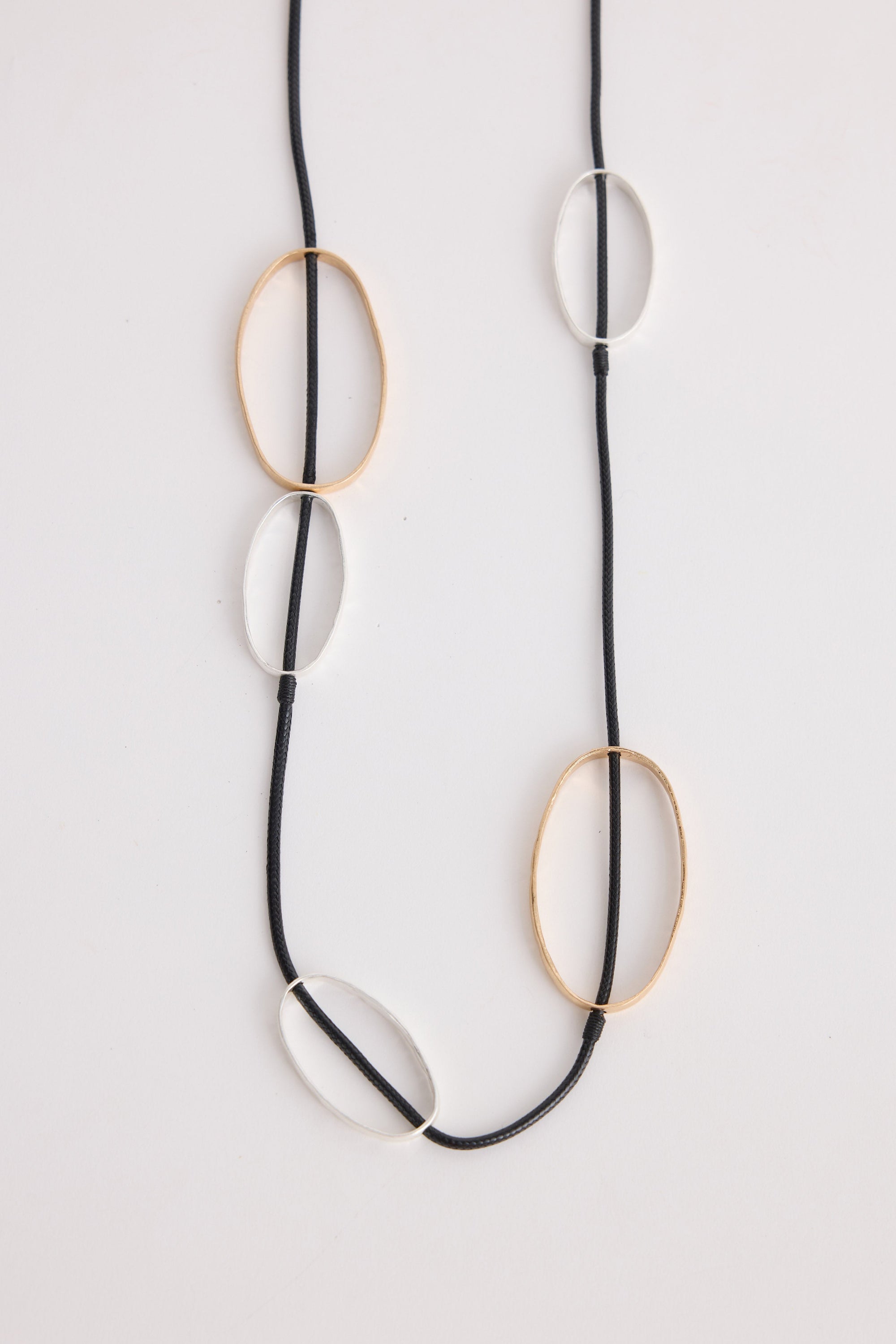 Rowling Necklace in gold and silver, with statement metal detailing, neckline styled view.