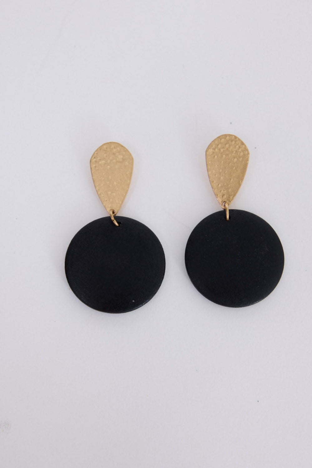 Parker Earrings in black and gold, with textured top detail, front view.