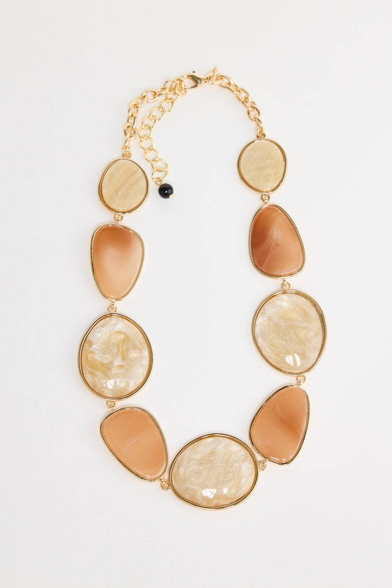 Ariel Necklace in salmon with white – flat lay of gold-tone chain with alternating salmon and cream resin-look oval links
