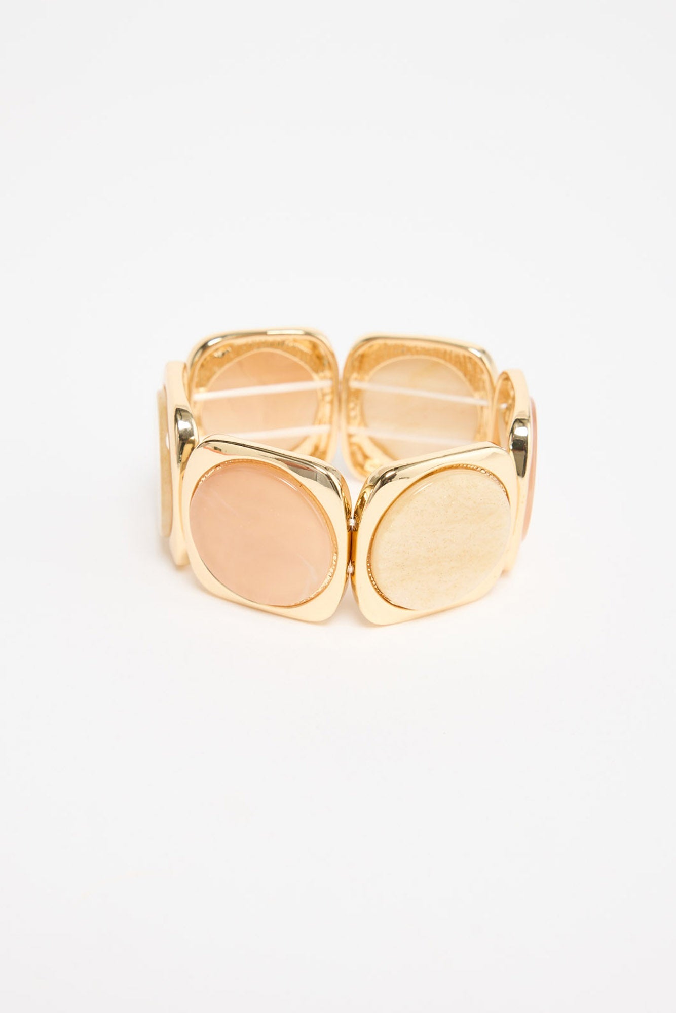Rover Stretch Bracelet in salmon with white, angled view showing the rounded resin discs and gold-tone frames