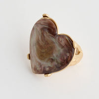 Heart-shaped stone ring on a white background