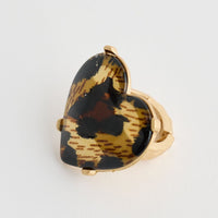 Heart-shaped tortoiseshell ring on a white background