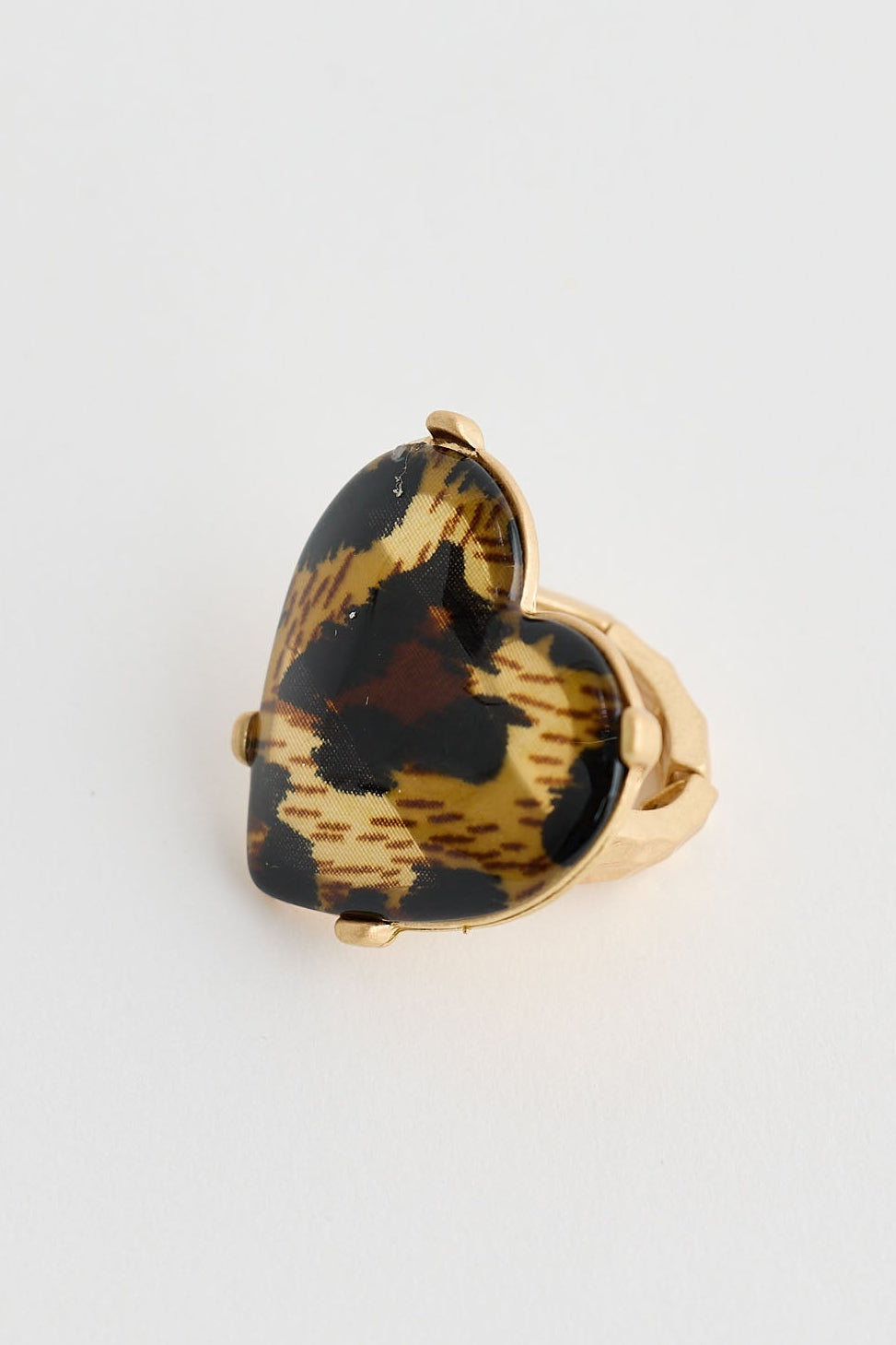 Heart-shaped tortoiseshell ring on a white background