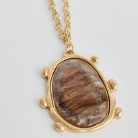 Necklace with a stone pendant on a light gray background