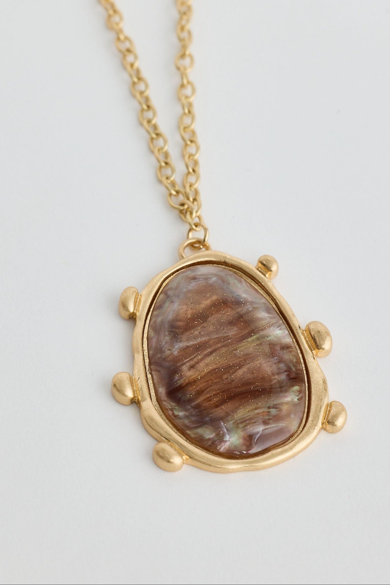 Necklace with a stone pendant on a light gray background