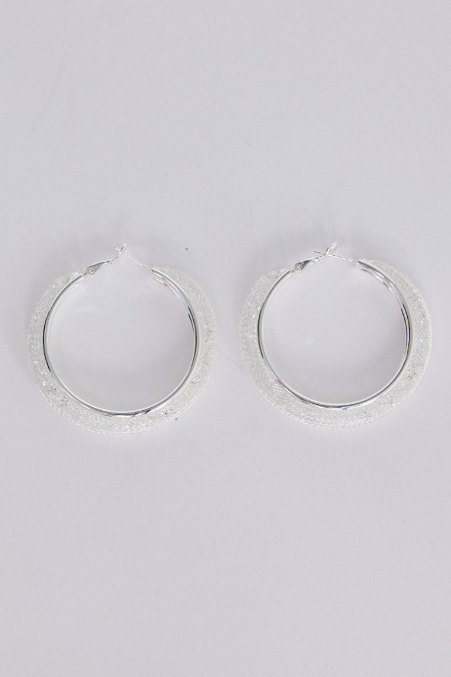 Graceful Earrings in silver with soft textured finish, front view.