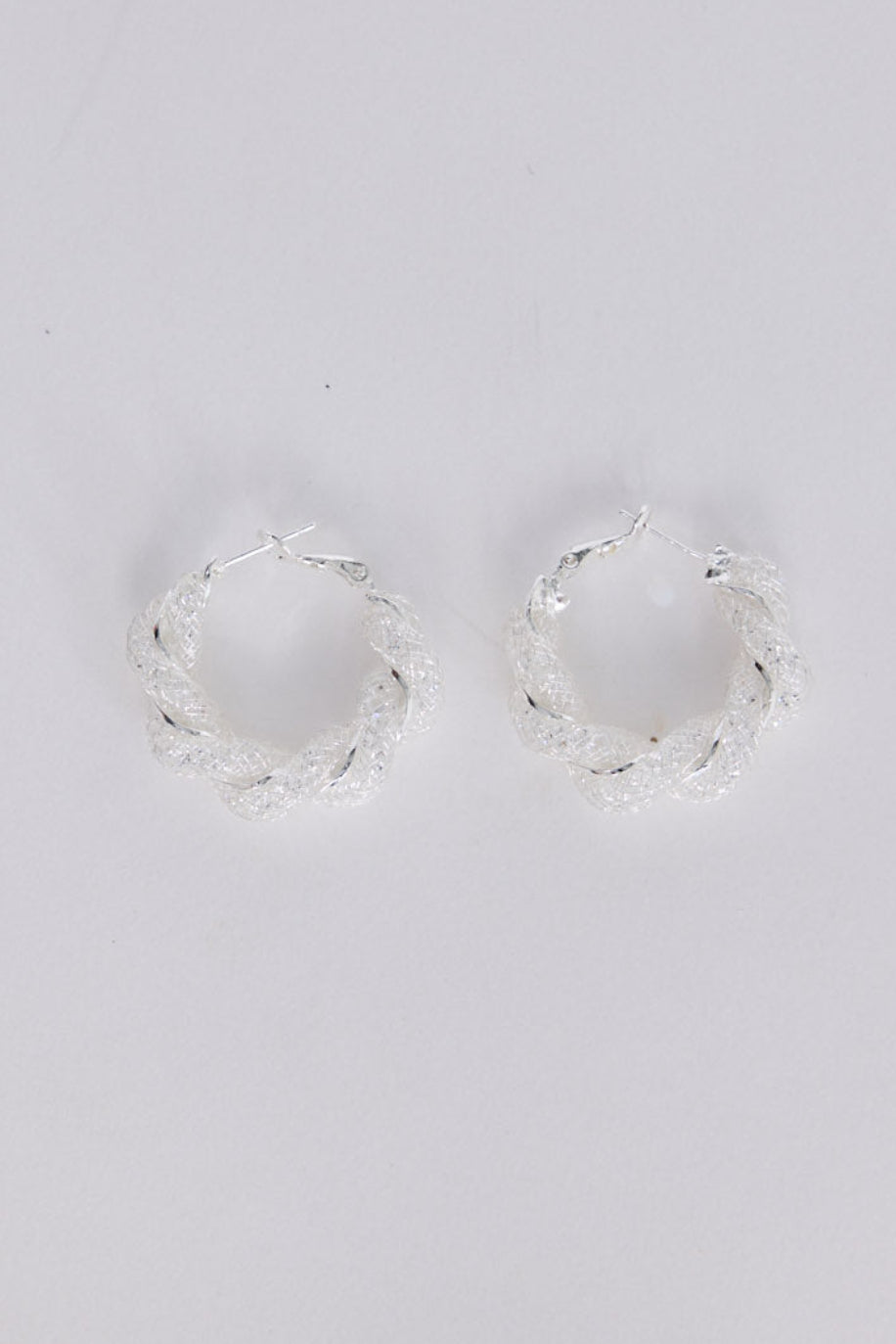 Opulence Earrings in silver with soft textured finish, front view.