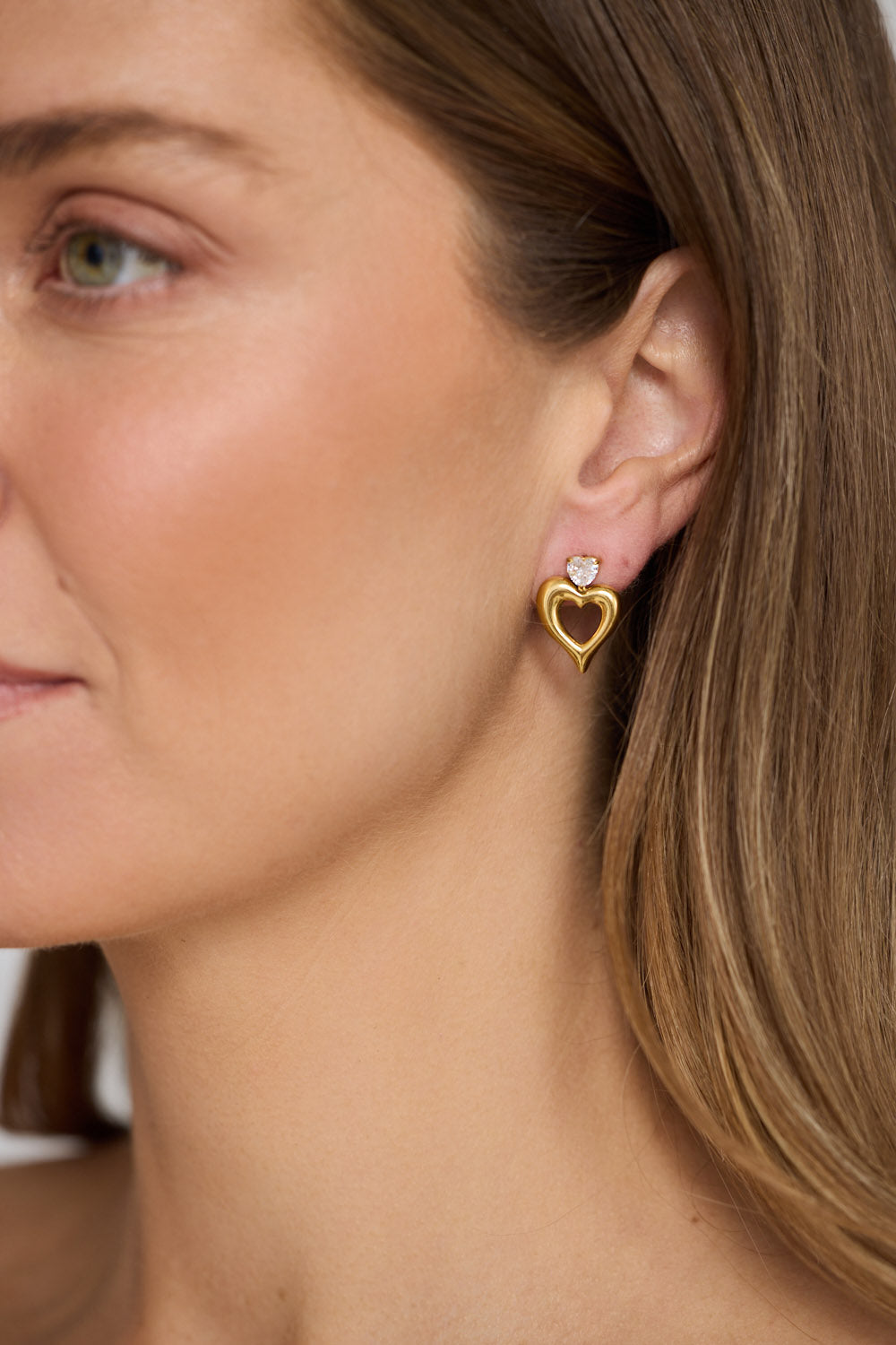 Model wearing Beloved Earrings in gold with a soft sculptural finish, close-up view.