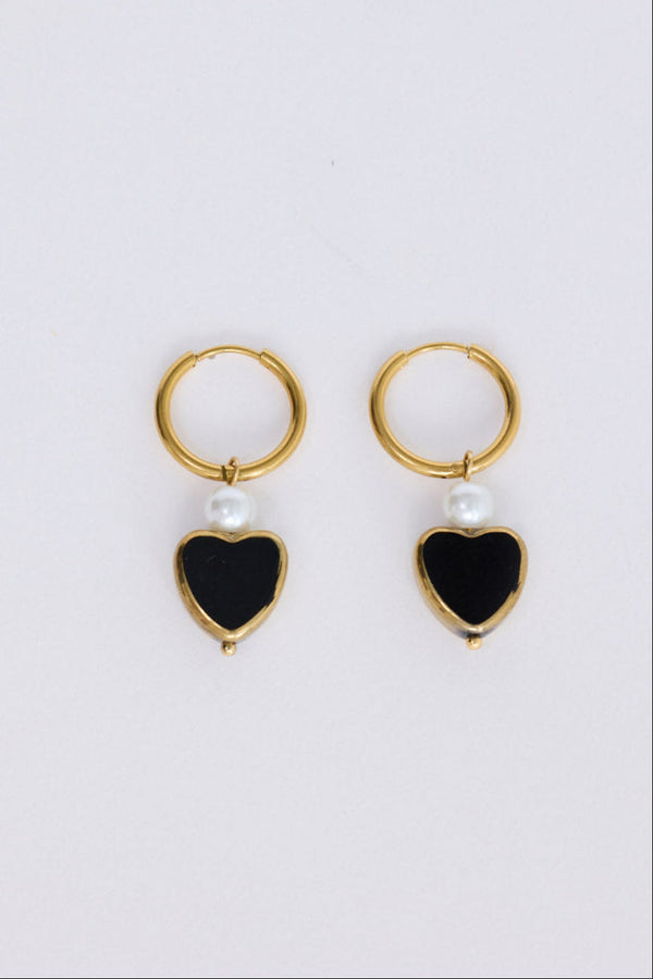 Mimi Earrings in black with bold heart charm detail, angled view.