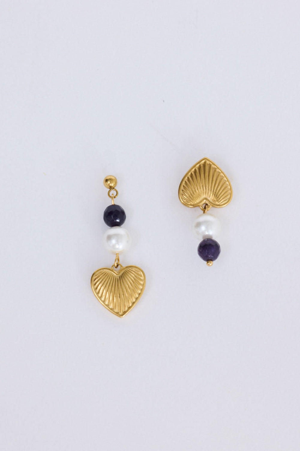 Janice Earrings in black with heart charm detail, angled view.