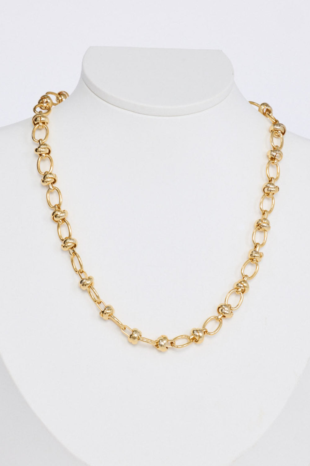 Uma Necklace in gold with a fine textured link design, front view.