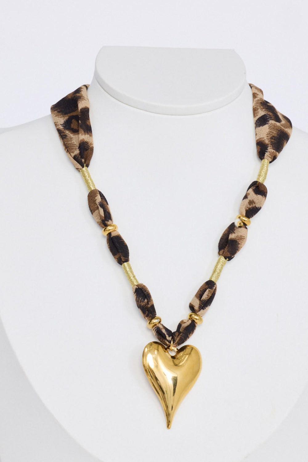 Ace Necklace in leopard with a bold heart pendant detail, side view.