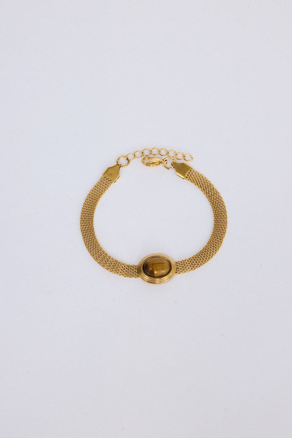 Dorris Bracelet in amber with a central oval stone detail, front view.