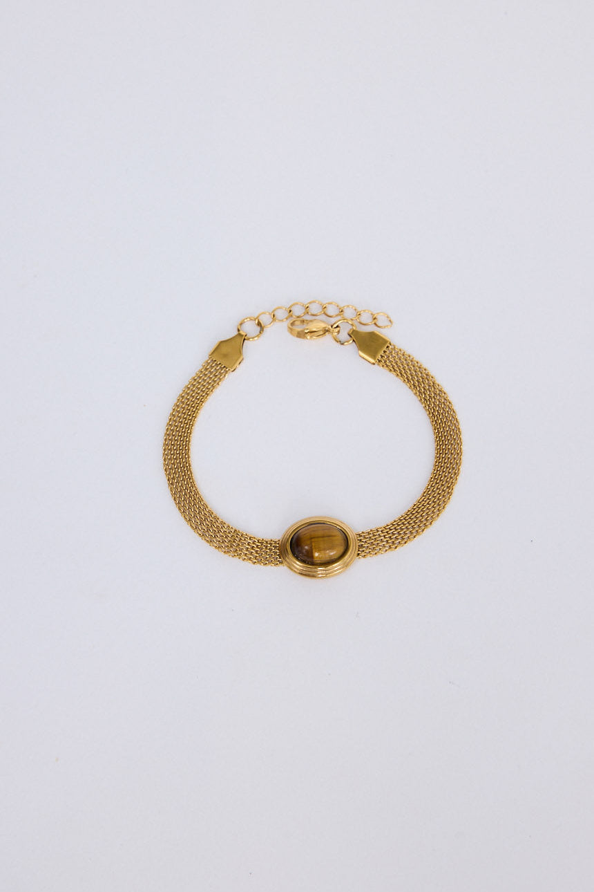 Dorris Bracelet in amber with a central oval stone detail, front view.