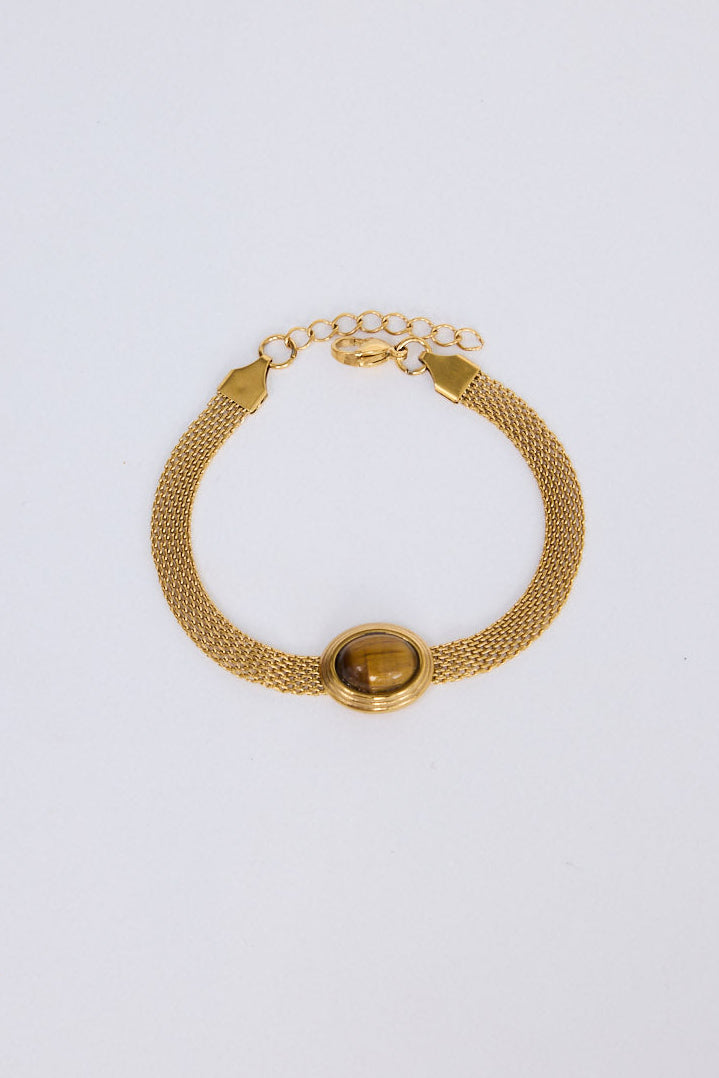Model wearing Dorris Bracelet in amber with a central oval stone detail, stacked styling view.