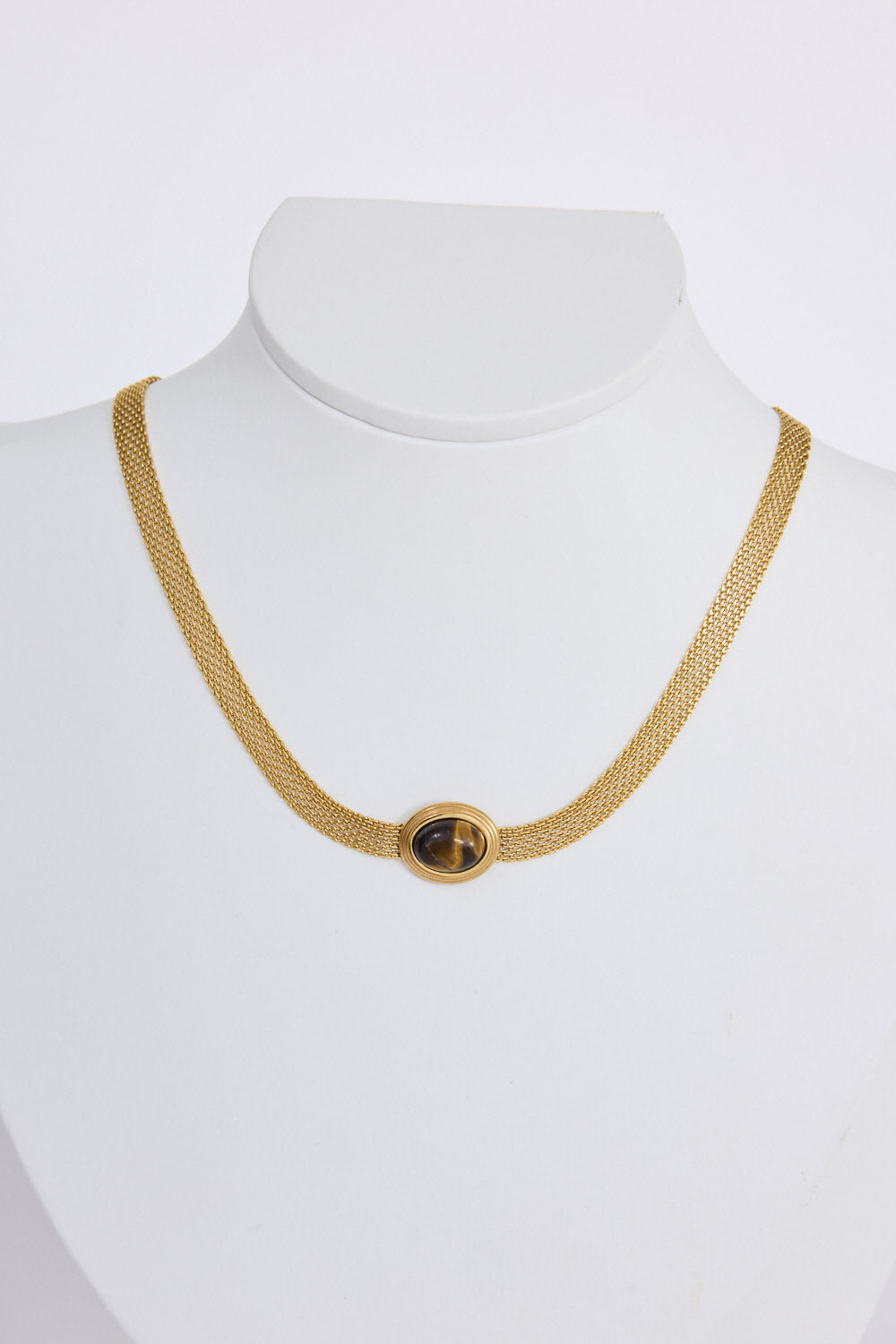 Dorris Necklace in amber with a central oval stone detail, side view.