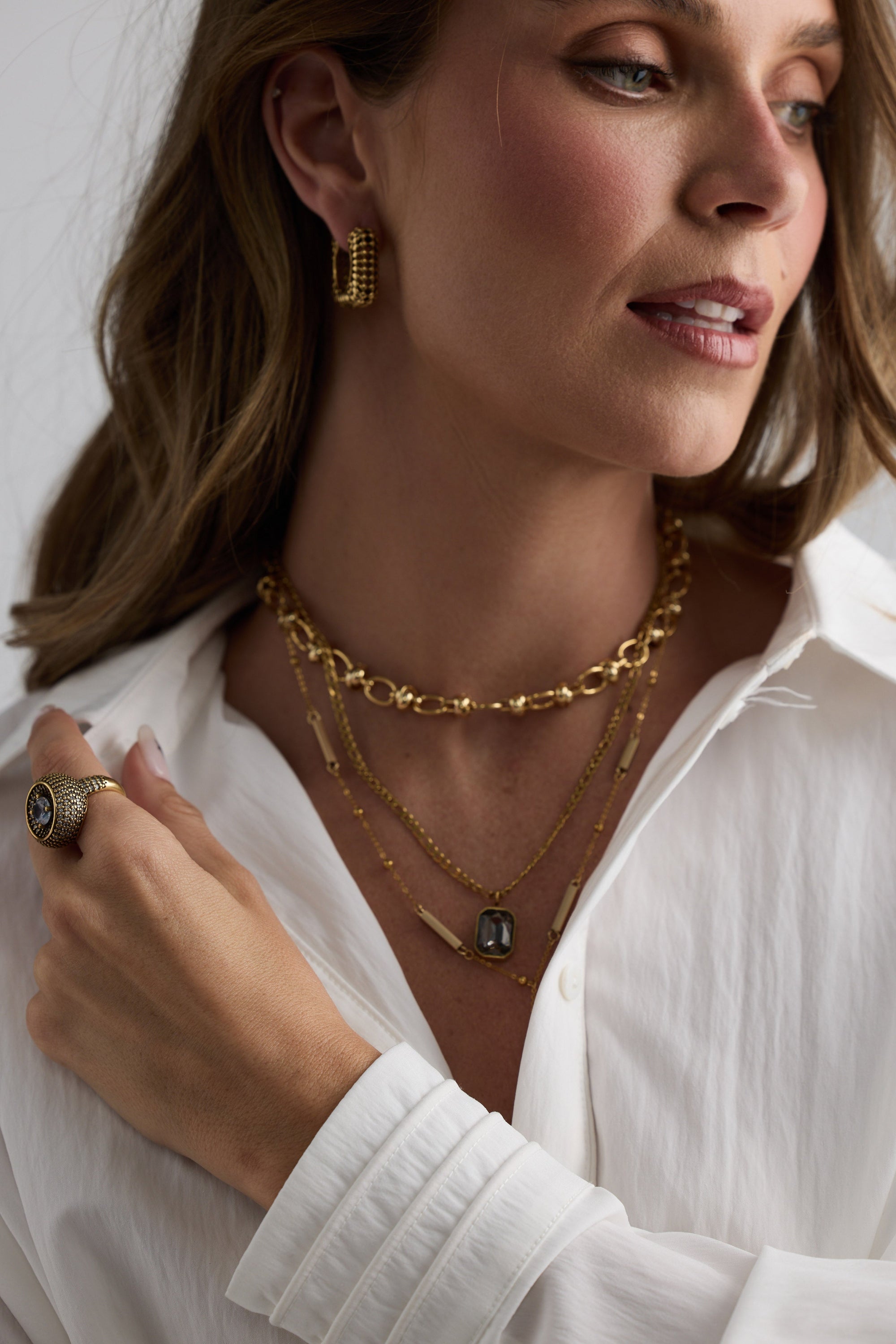 Model wearing Bovina Necklace in smoke with a faceted rectangular pendant, pendant close-up view.
