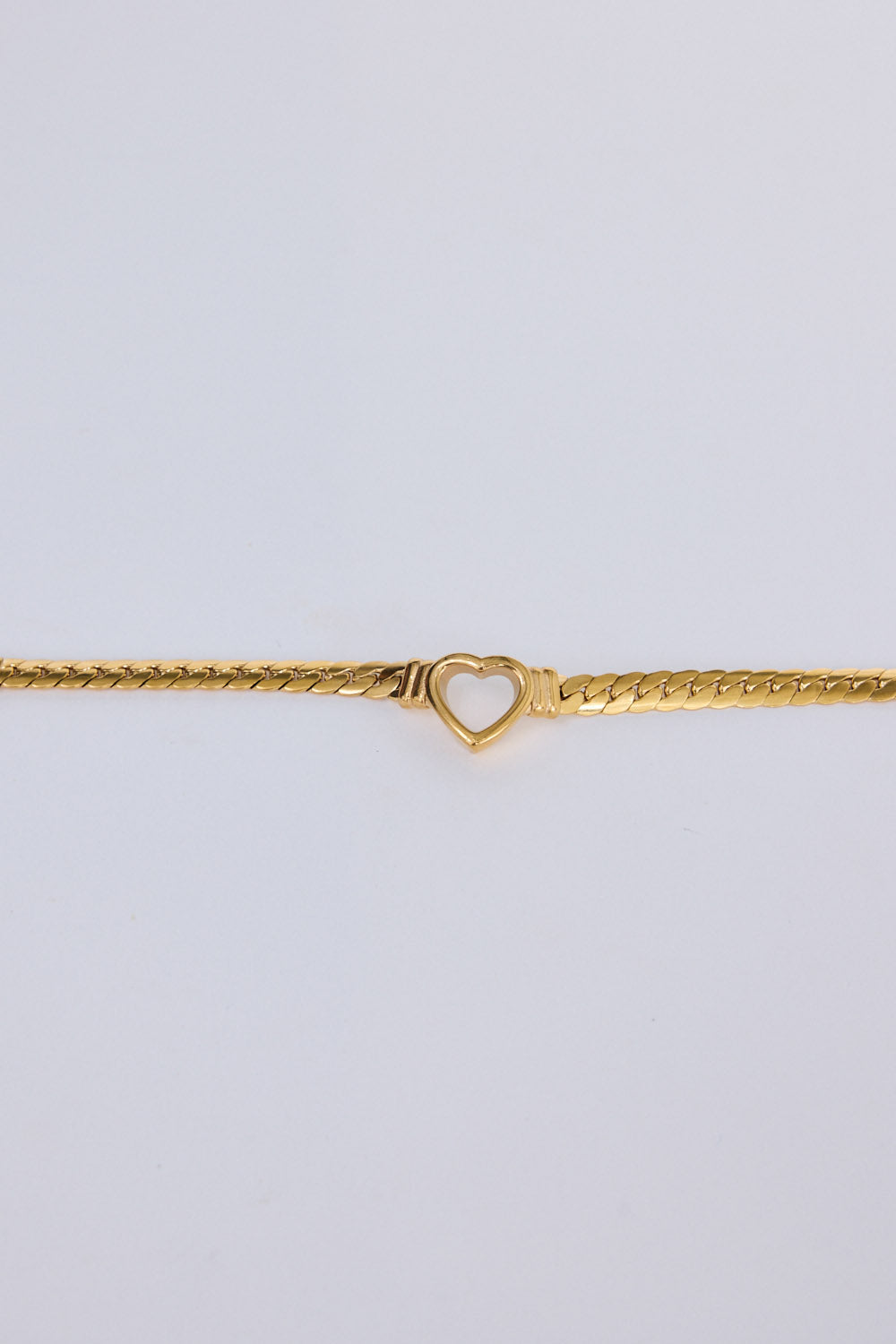Hearts Bracelet in gold with delicate heart link detailing, flat lay detail view.