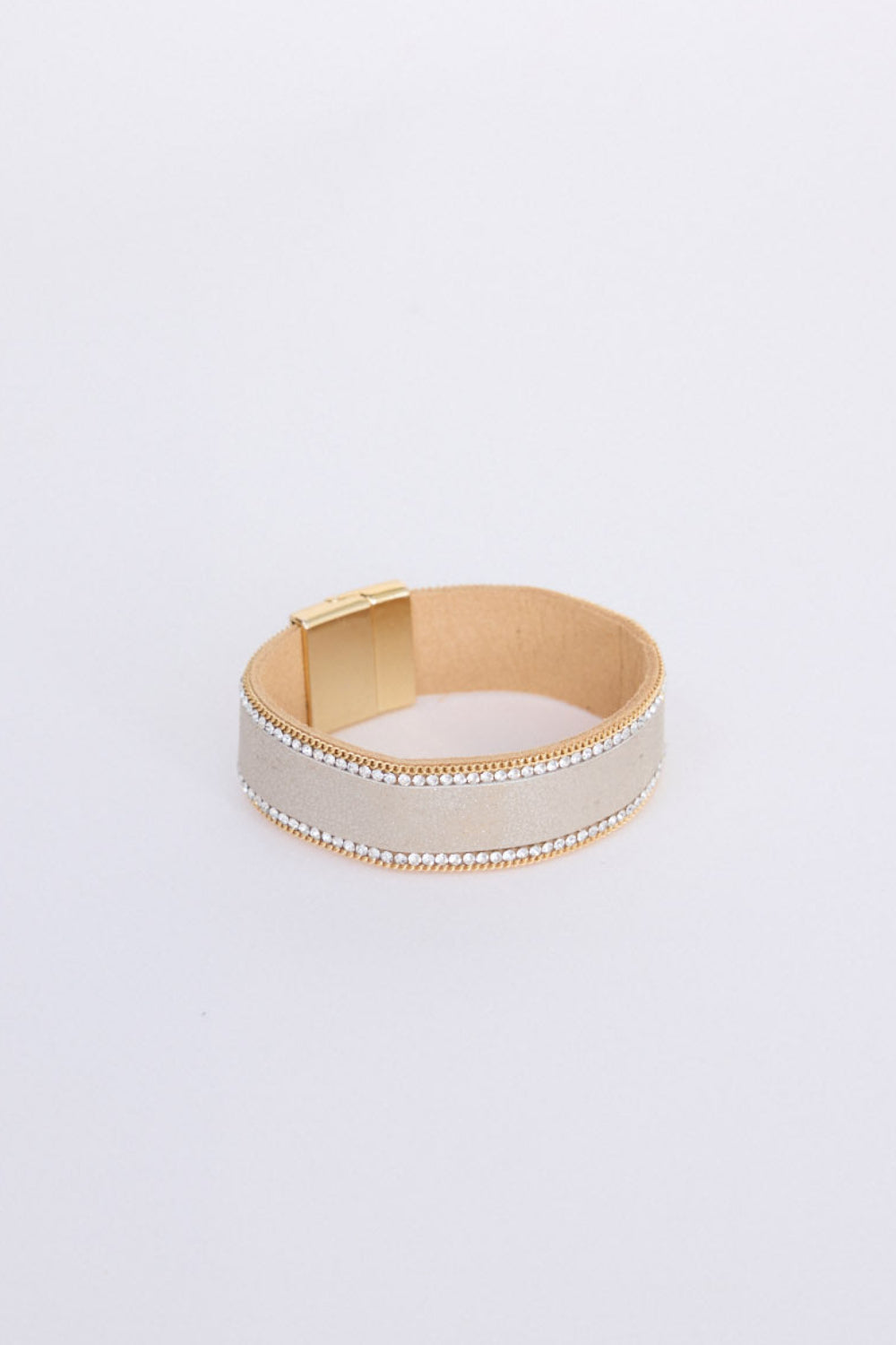 Hilda Bracelet in gold with delicate crystal detailing, angled view.