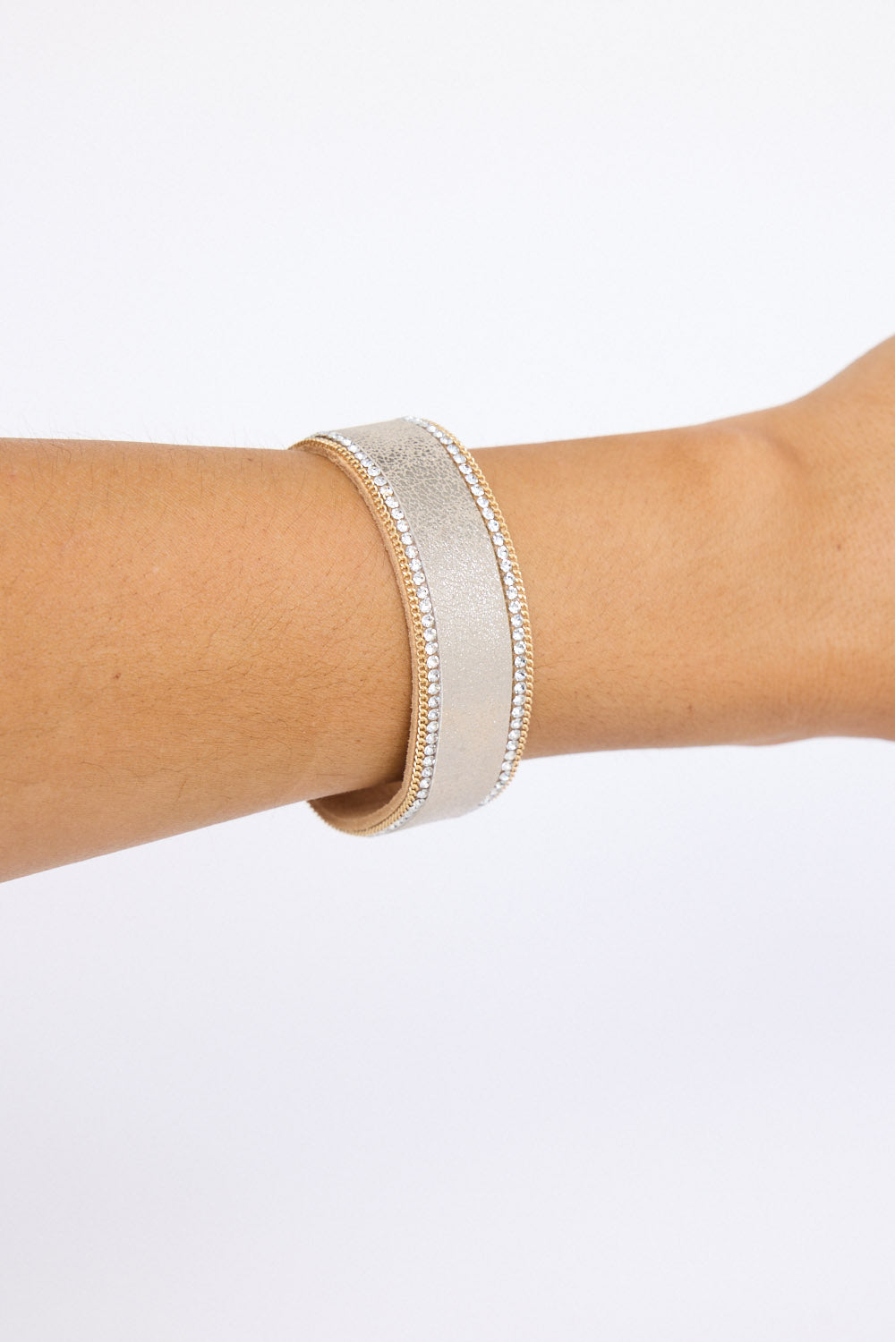 Model wearing Hilda Bracelet in gold with delicate crystal detailing, on-wrist view.