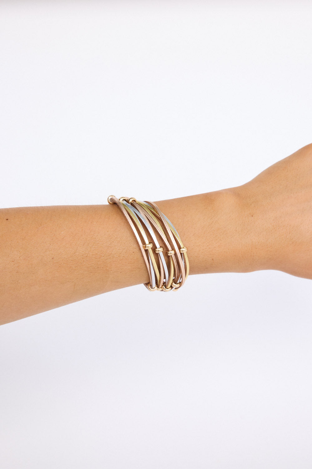 Model wearing Ainsley Bracelet in metallic with fine metallic cords, on-wrist view.