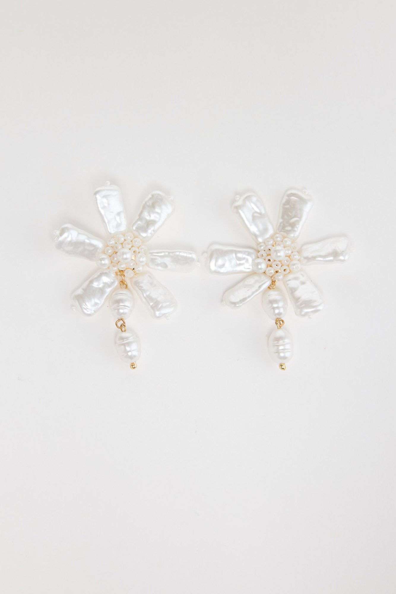 Pair of Zara floral earrings in Pearl showing freshwater pearl petals, beaded centre and pearl drop on a white background