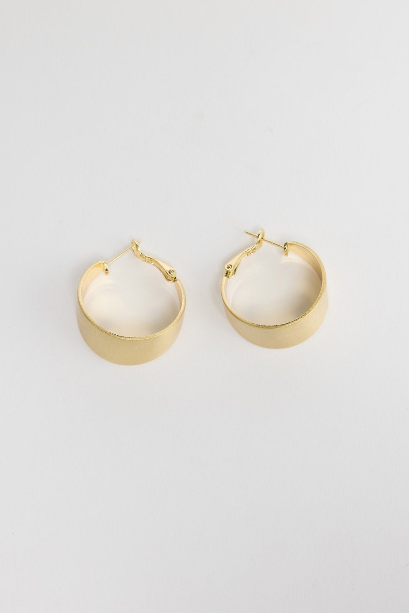 Siren Earrings in Gold, alternate angle showing the width and satin finish of the gold hoop.