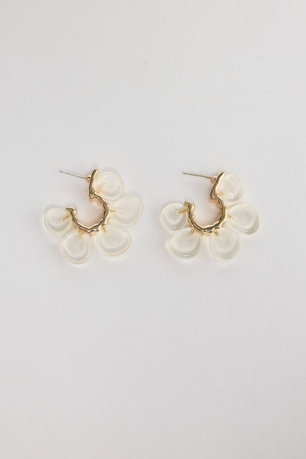 Matilda Earrings in Clear – gold-tone huggie earrings with five frosted clear resin flower petals, shown flat on a white background.