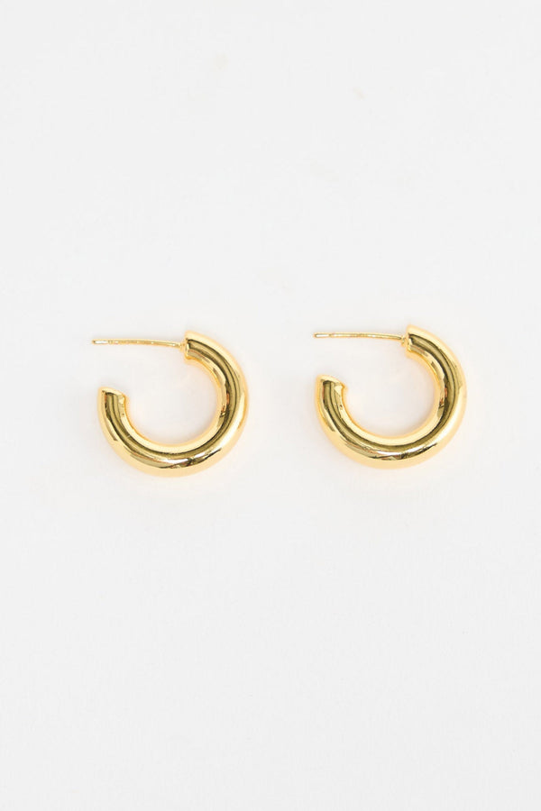 Thick Hoops S in Gold – small polished gold-tone tube hoop earrings shown flat on a white background.