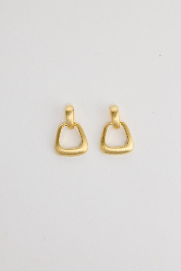 Swell Earrings in Gold – matte gold-tone geometric ring drop earrings shown flat on a white background.