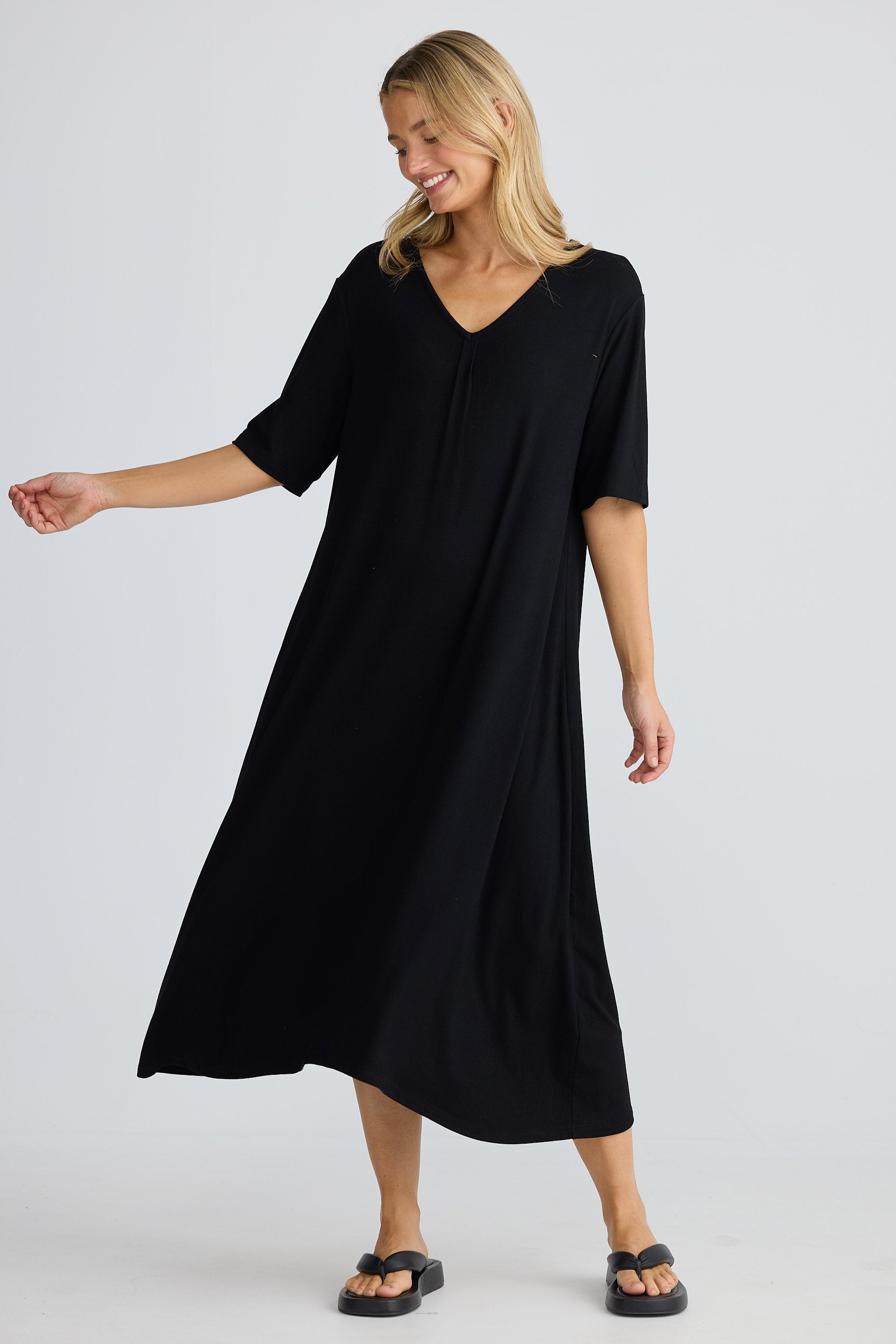 Woman wearing a black dress on a white background