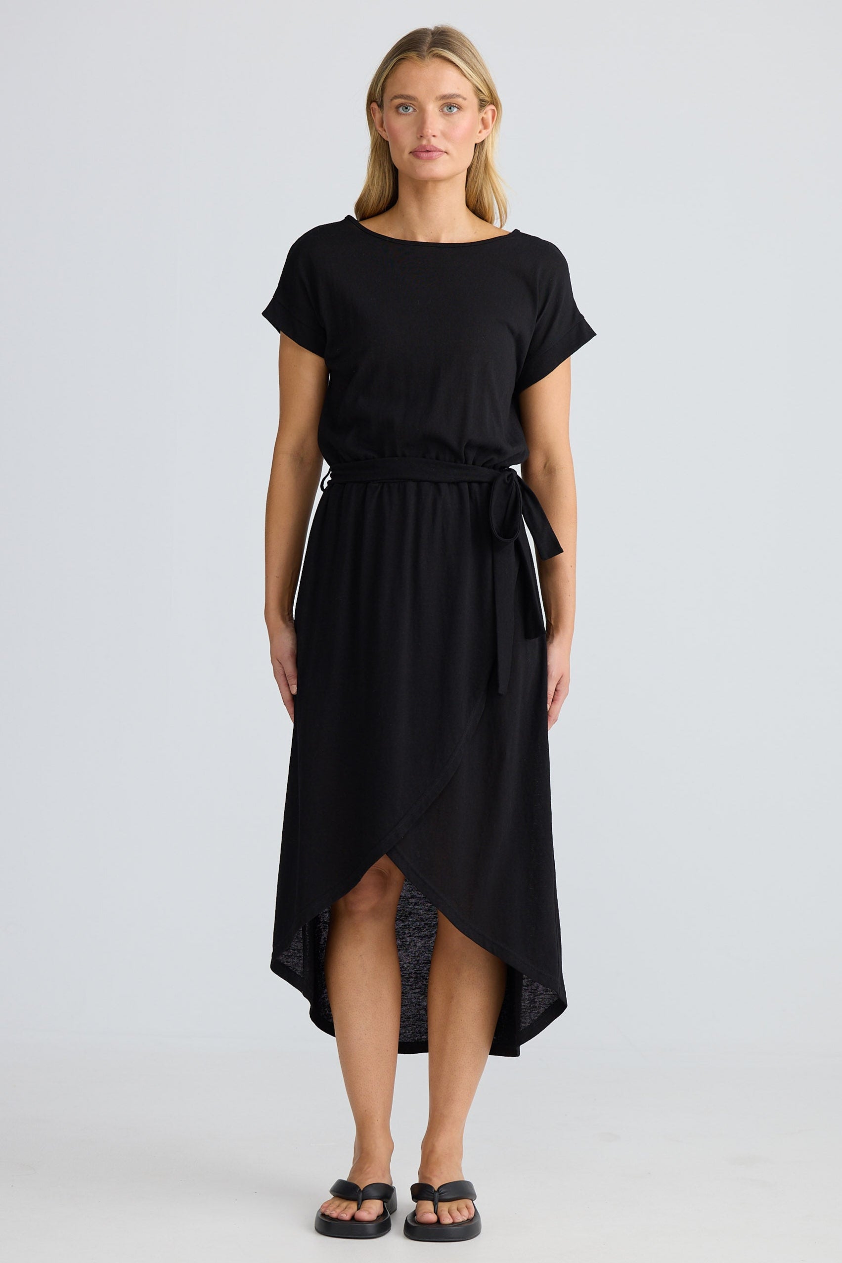 Woman wearing a black dress with a white background