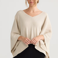 Affirm Cape in cream, showing draped cape shape.