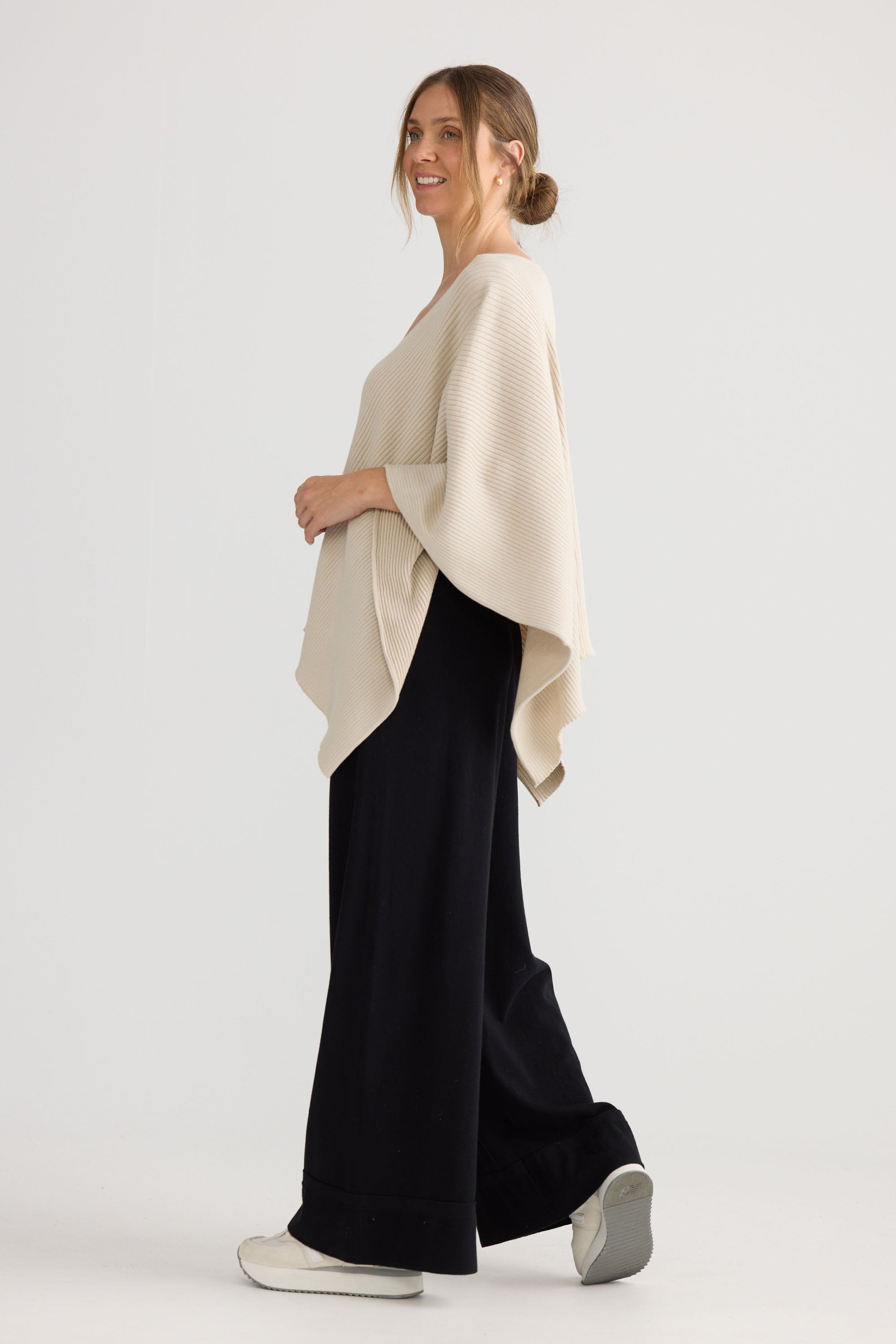 Model wearing Affirm Cape in cream.