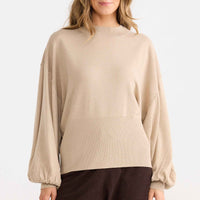 Model wearing Ember Knit in oat.
