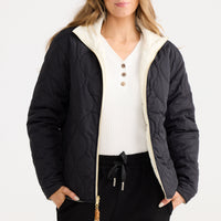Model wearing Ellis Puffer in black with cream.