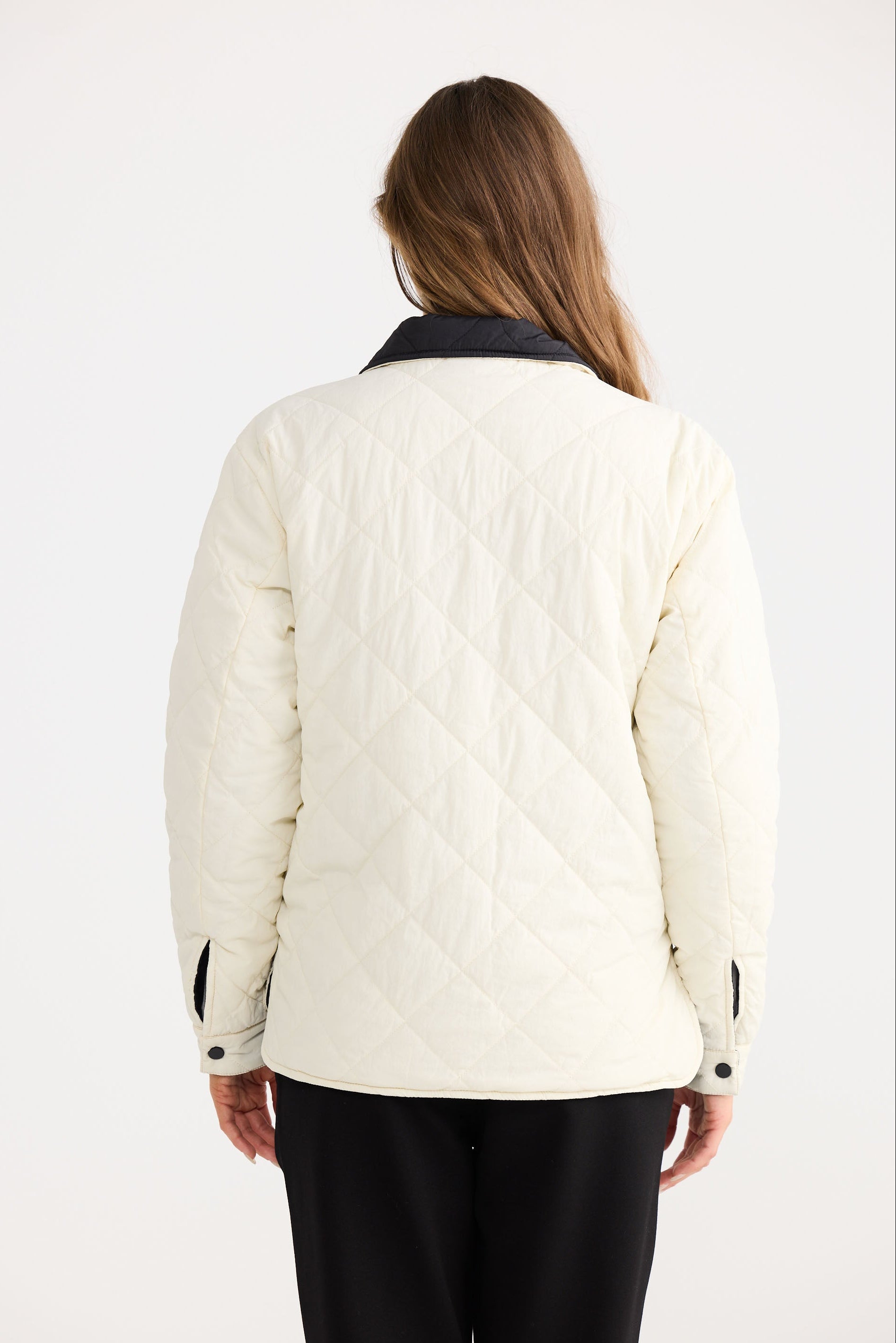 Model wearing Ellis Puffer in black with cream, relaxed styling image.