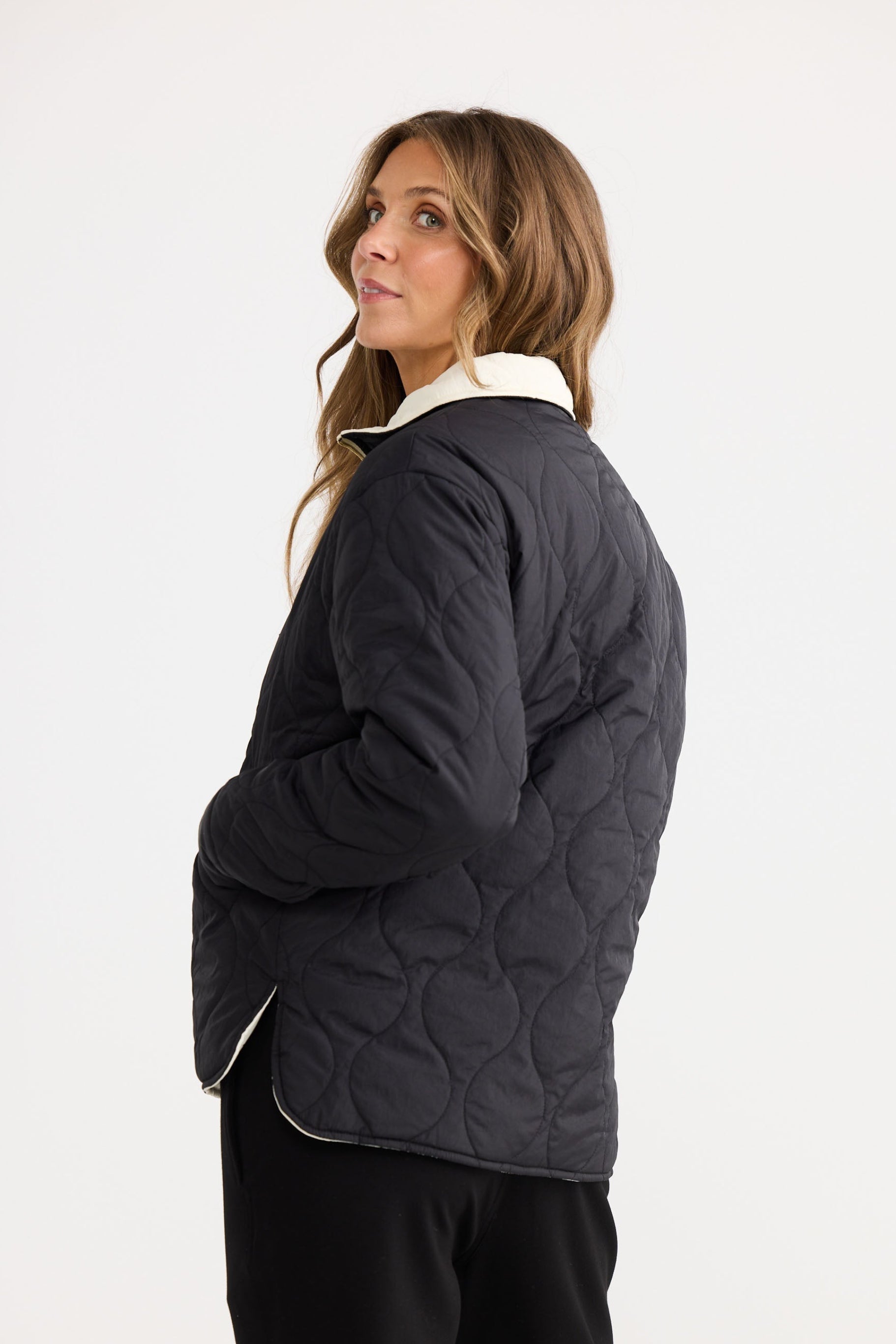 Ellis Puffer in black with cream, shown in a styled product image.