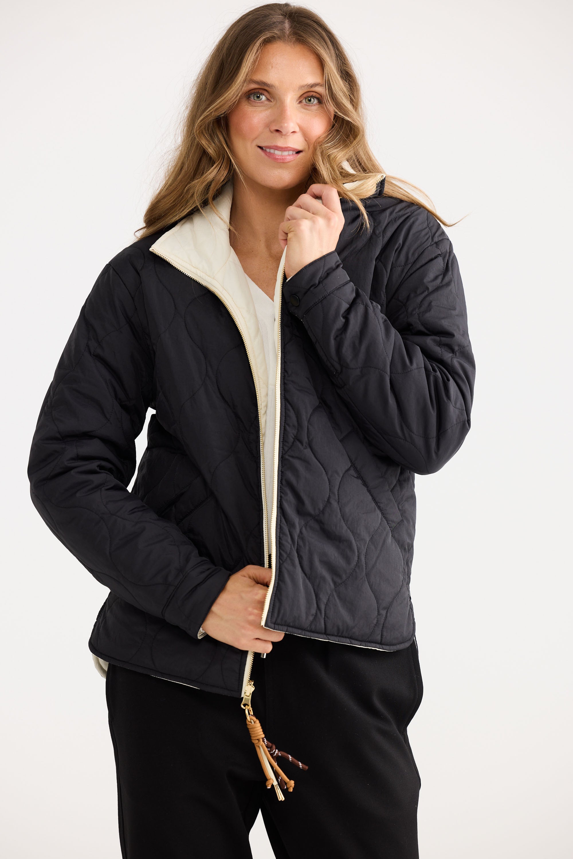Ellis Puffer in black with cream, styled with a relaxed outfit.