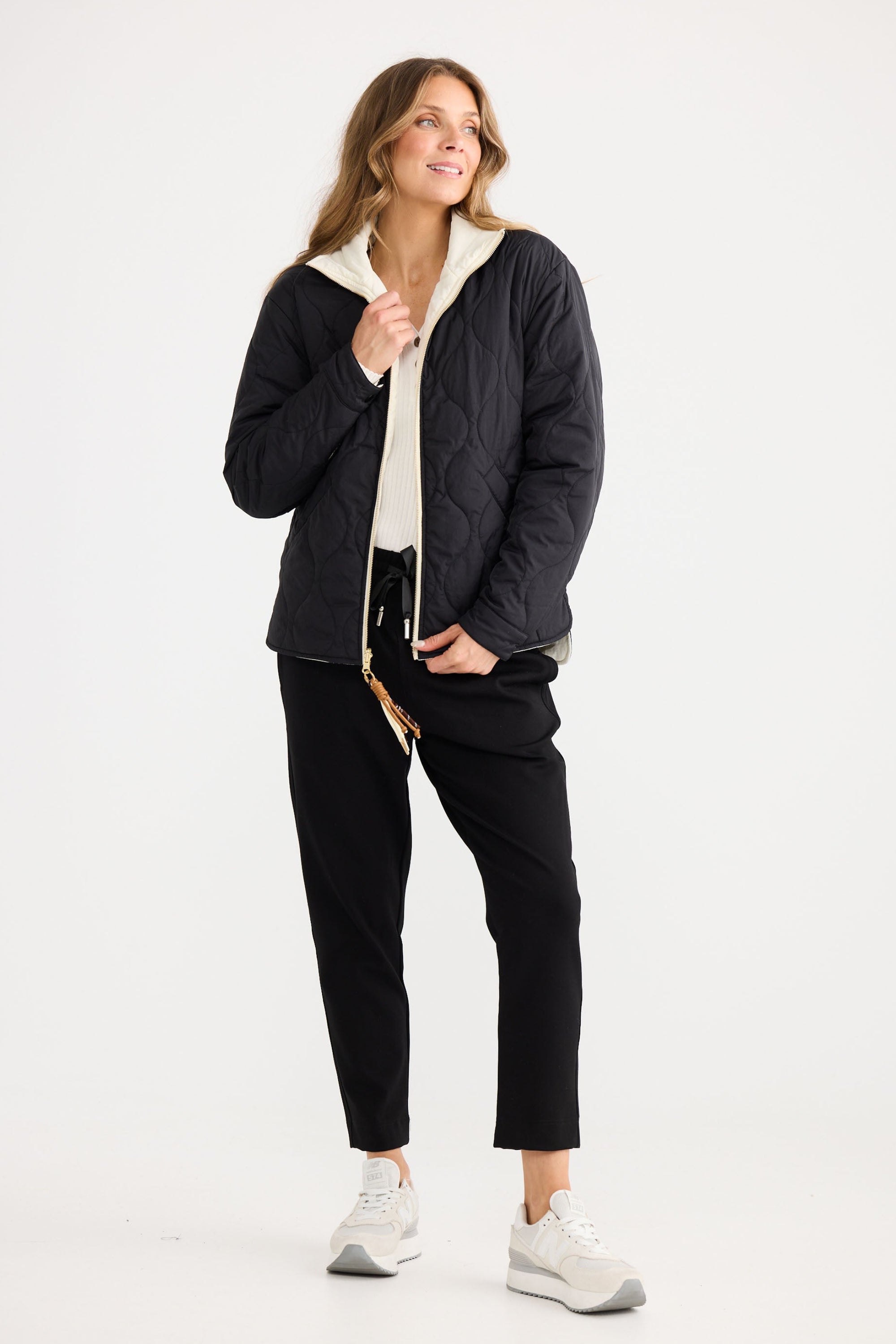 Model wearing Ellis Puffer in black with cream, showing puffer quilting.