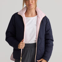 Ellis Puffer in navy with pink, shown on model.
