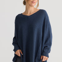 Model wearing Chill Top in navy, showing v-neckline.
