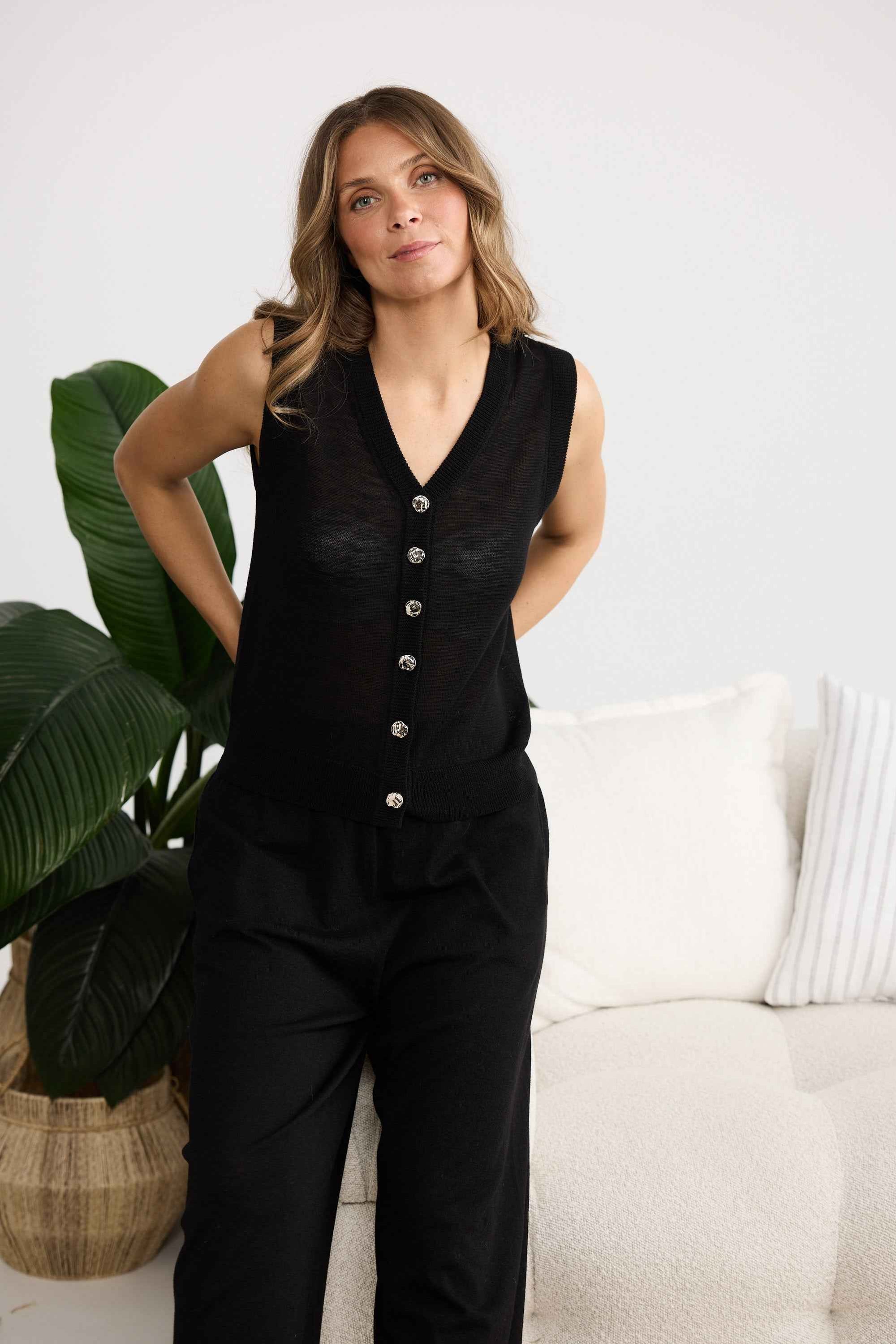 Campaign image of model wearing Etta Knit Vest in black.