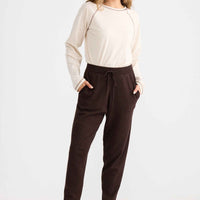 Model wearing Woodside Pant in chocolate.