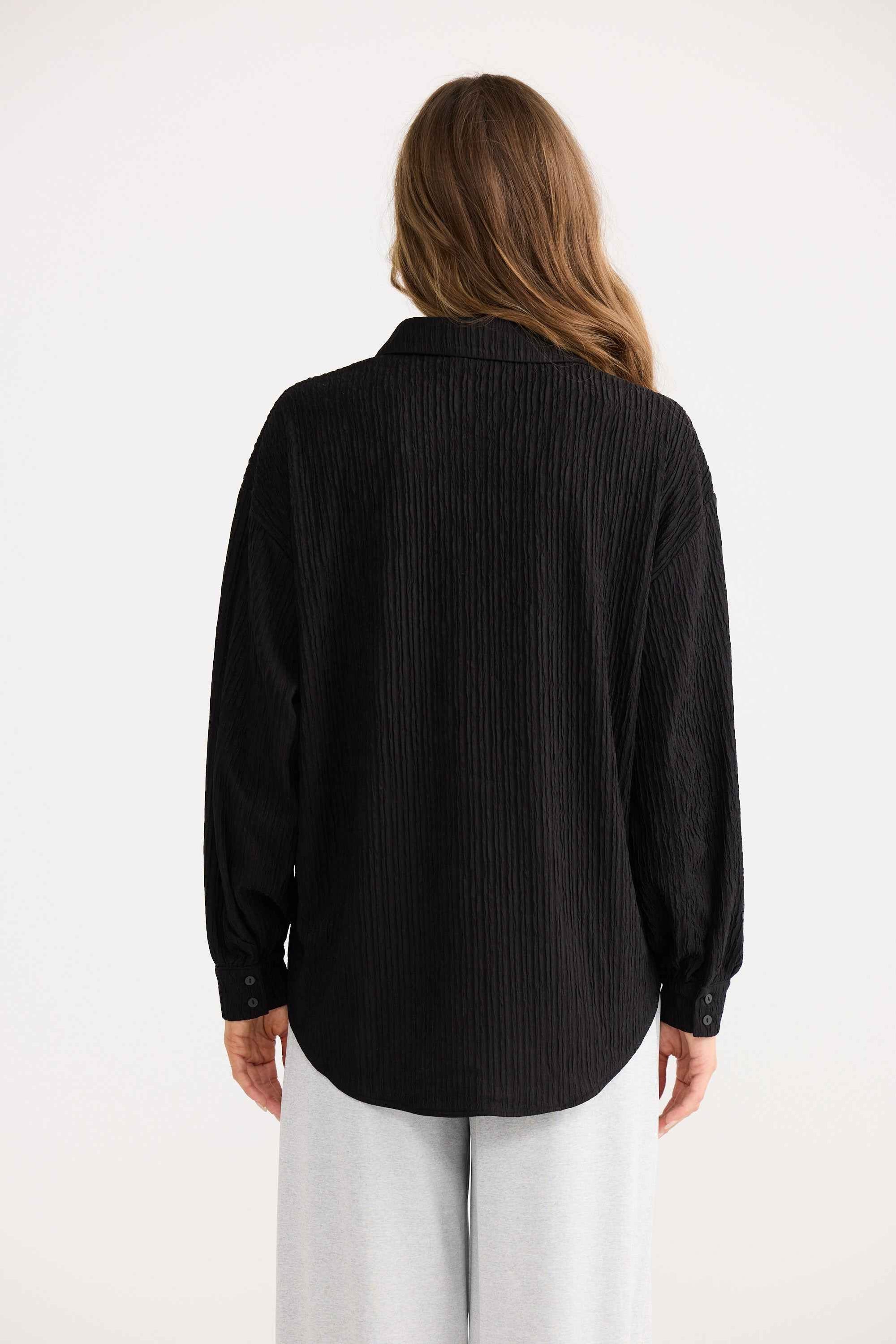 Ivy Shirt in black, showing open collar.